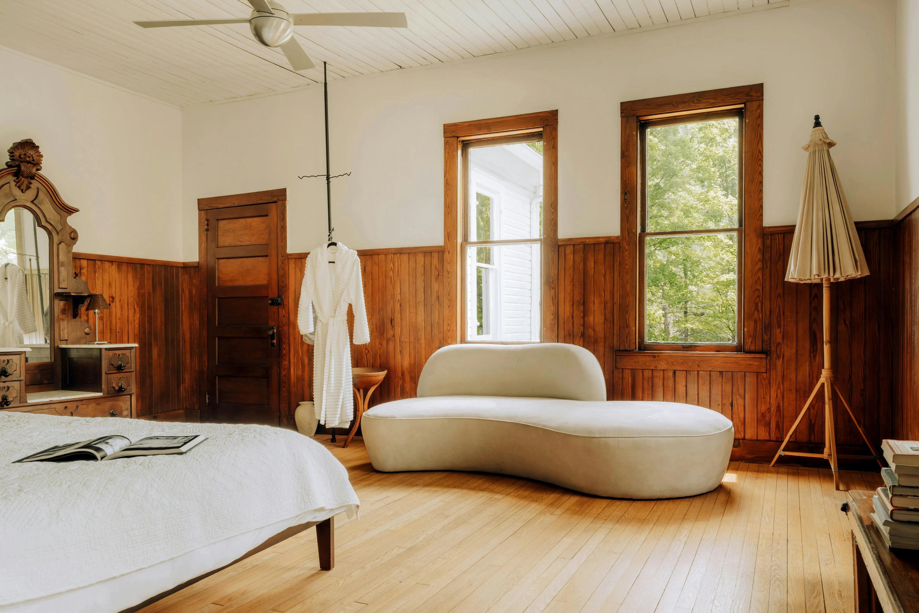 A calm bedroom with natural wood and soft bedding