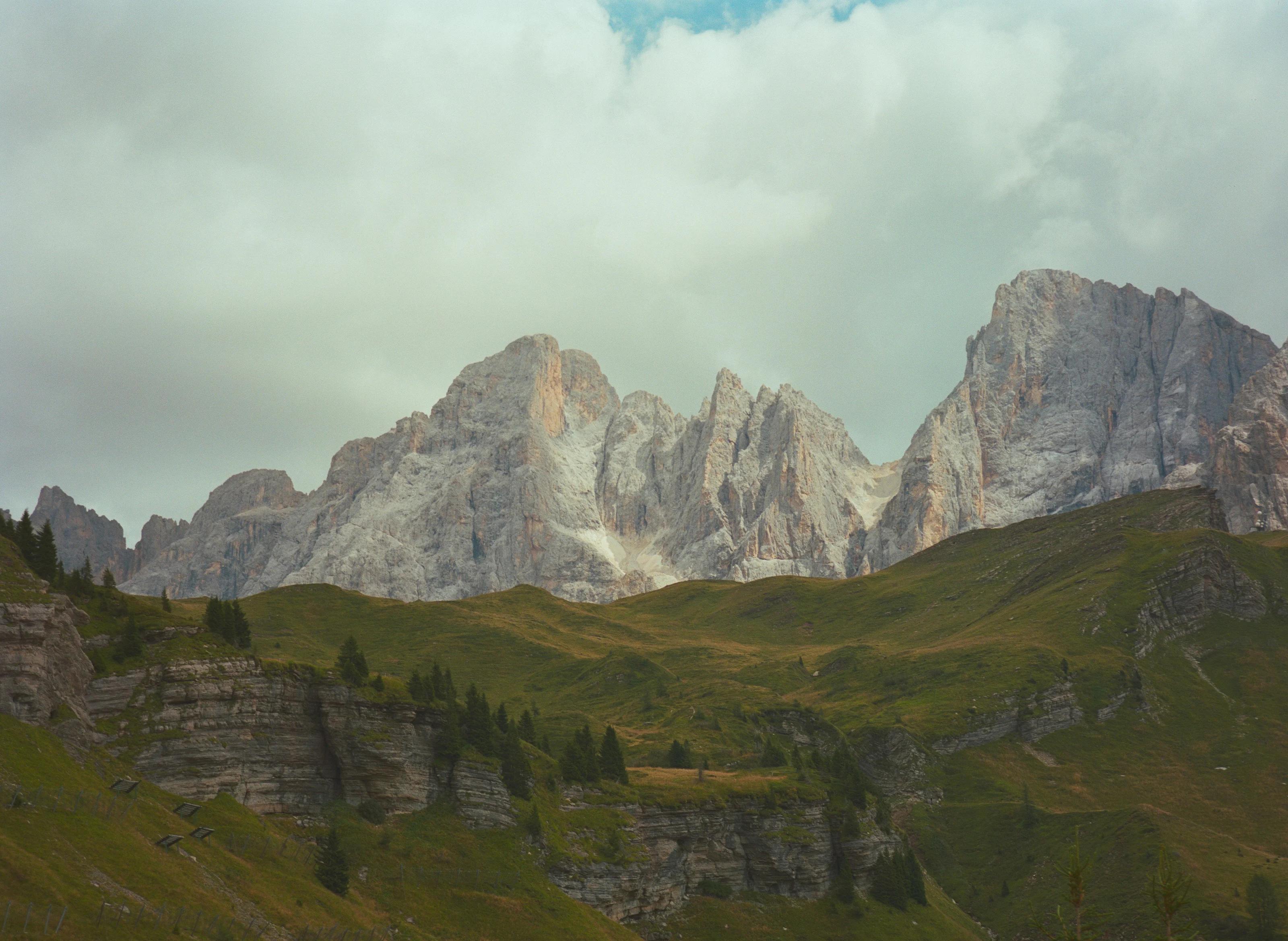 The full Dolomite skyline above green Alpine slopes